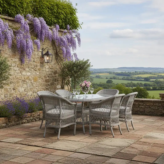 Outdoor patio set with table and chairs on a stone patio with a scenic view.