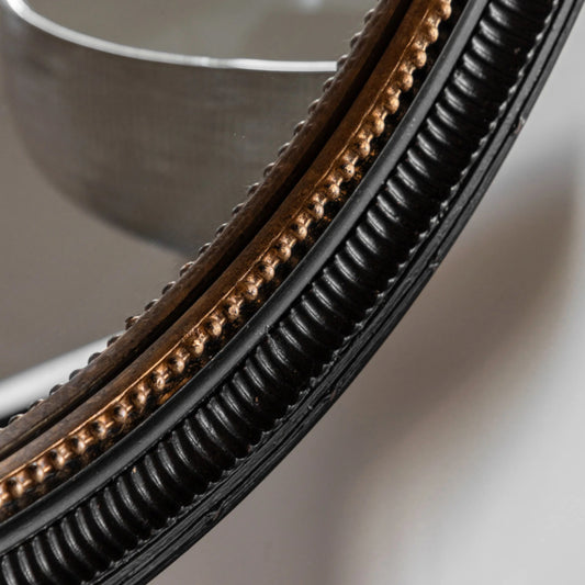Close-up of a circular metal object with a ribbed edge on a neutral background