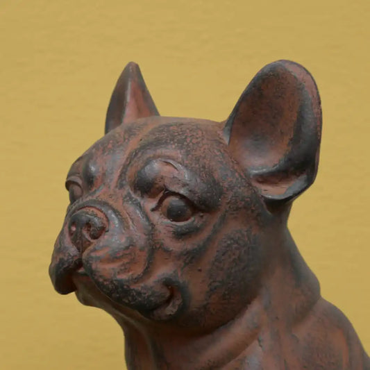 Bronze statue of a dog on a gold background