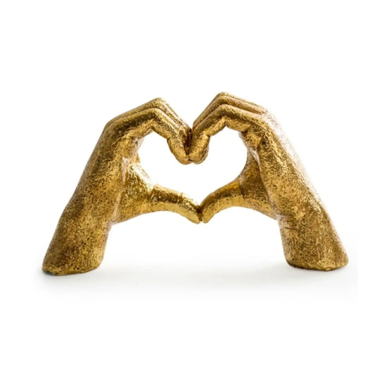 Bronze sculpture of two hands forming a heart shape on a white background