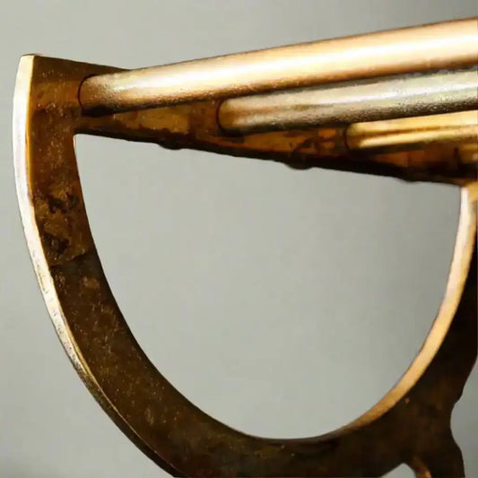 Close-up of a bronze axe head on a gray background