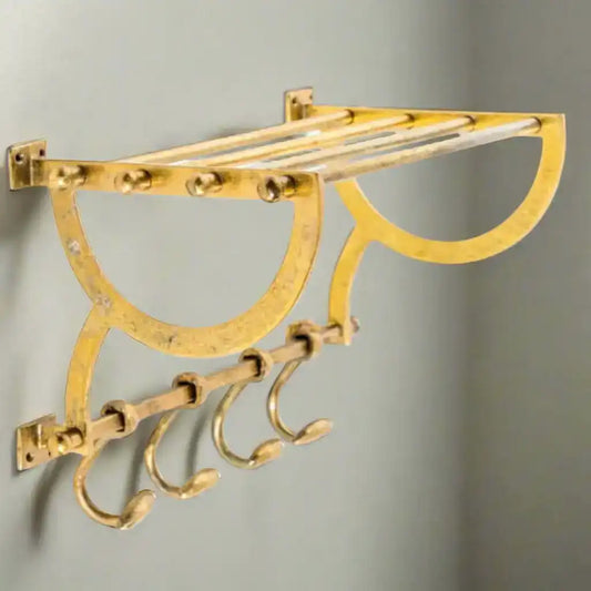 Gold wall-mounted hook rack with multiple hooks on a white background
