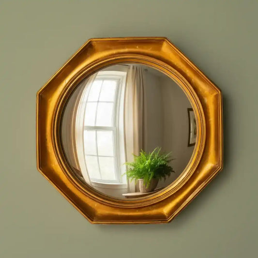 Gold octagonal mirror on a green wall