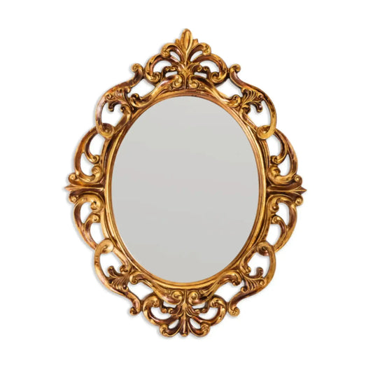 Decorative gold mirror with intricate patterns on a white background
