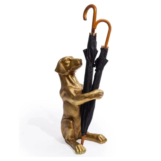 Bronze dog-shaped umbrella stand holding an umbrella on a white background