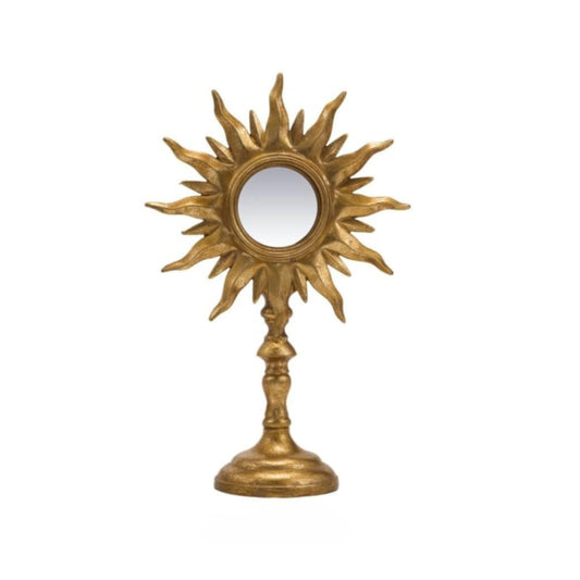Decorative gold sun-shaped mirror on a white background