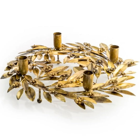 Decorative gold wreath with candle holders on a white background