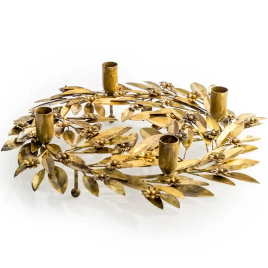 Decorative gold wreath with candle holders on a white background