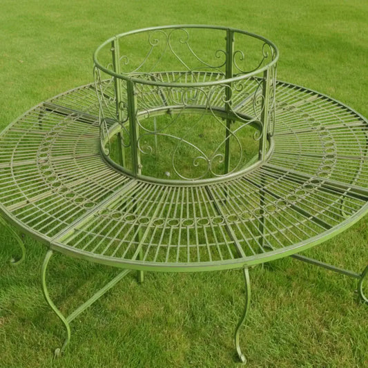 Decorative metal garden table on a grassy background