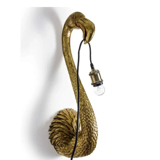 Gold flamingo-shaped wall lamp with a bulb on a white background