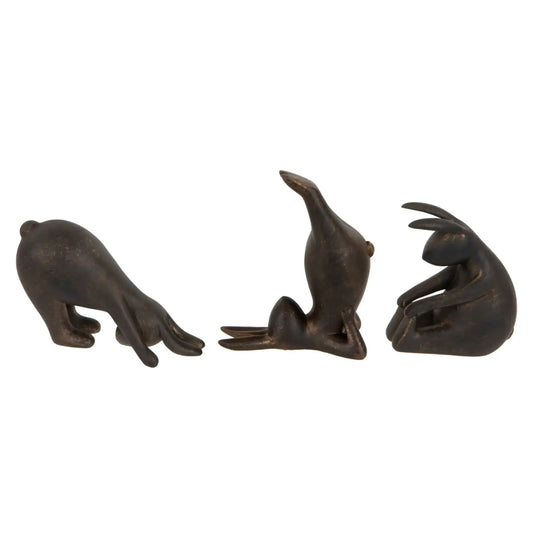 Three bronze seal figurines on a white background