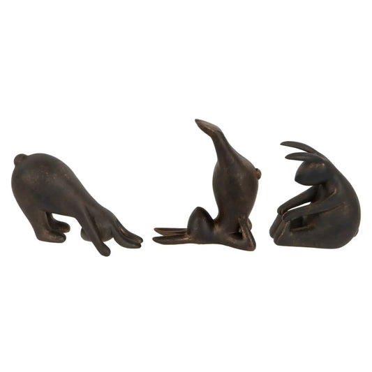 Three bronze seal figurines on a white background