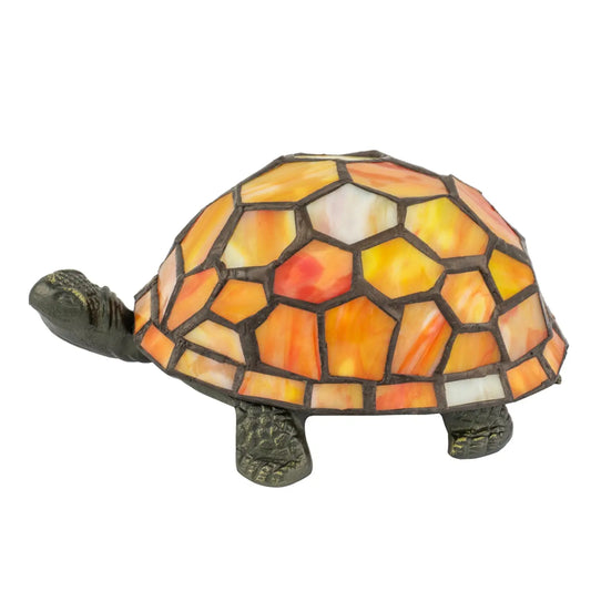A decorative tortoise figurine with a mosaic stained-glass shell in shades of orange, yellow, and white, set against a plain white background.