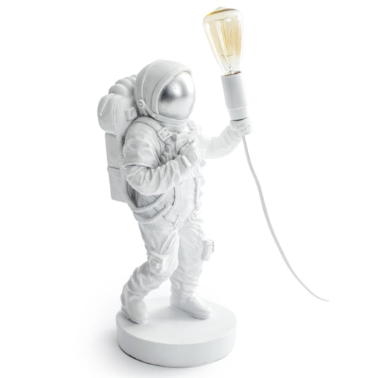 White astronaut lamp with a light bulb on a white background