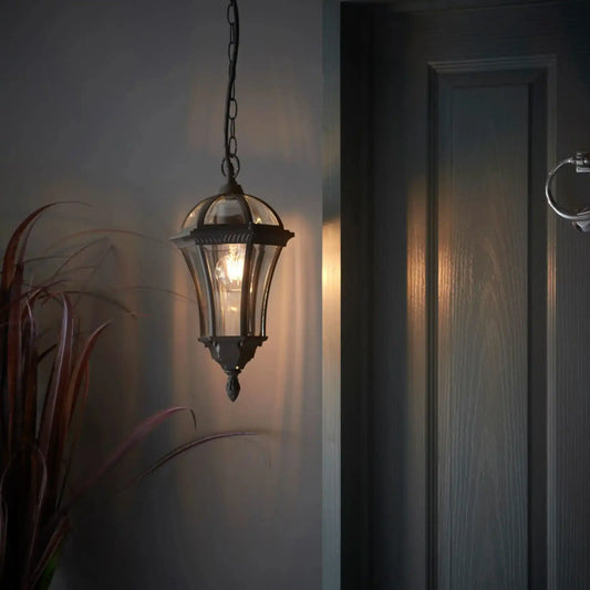 Decorative hanging light fixture on a wall next to a door