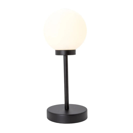 Table lamp with a black base and white shade on a white background