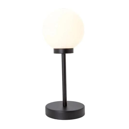 Table lamp with a black base and white shade on a white background