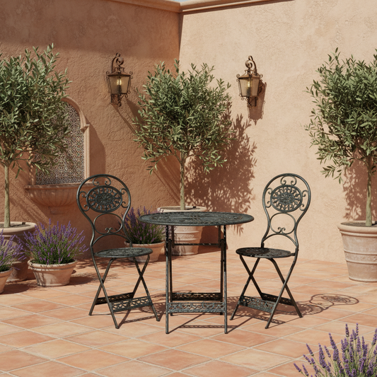 Outdoor patio set with table and chairs on a tiled floor against a wall with potted plants and a water feature.