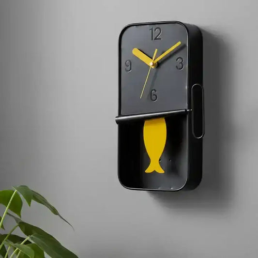 Wall clock with yellow fish design on a white background