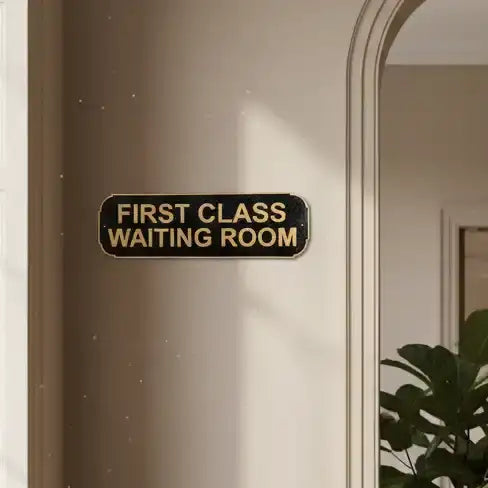 Door with a sign reading 'First Class Waiting Room' on a neutral background