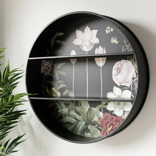 Round decorative shelf with floral design on a white wall