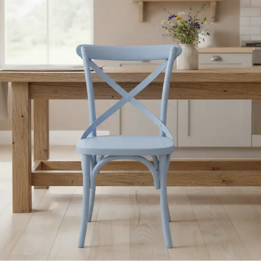 Light blue chair in front of a wooden dining table with a vase of flowers on a kitchen counter.