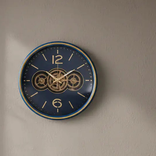 Wall clock with gear design on a beige wall