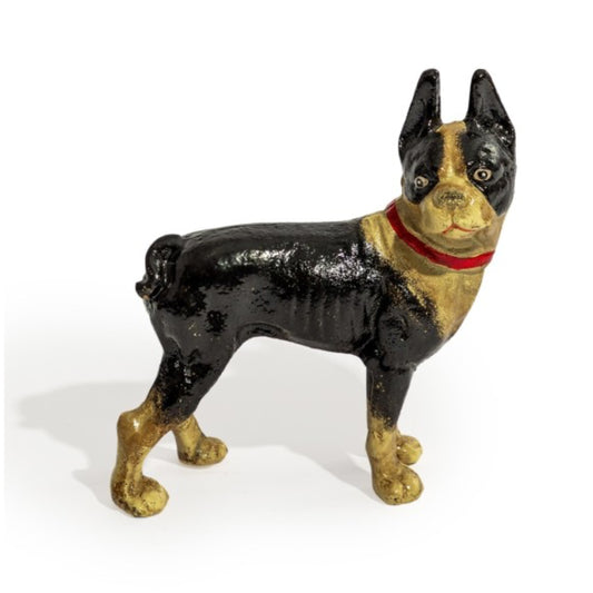 Vintage cast iron dog doorstop with black and gold coloring on a white background
