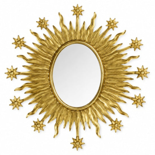 Decorative gold sunburst mirror with star accents on a white background