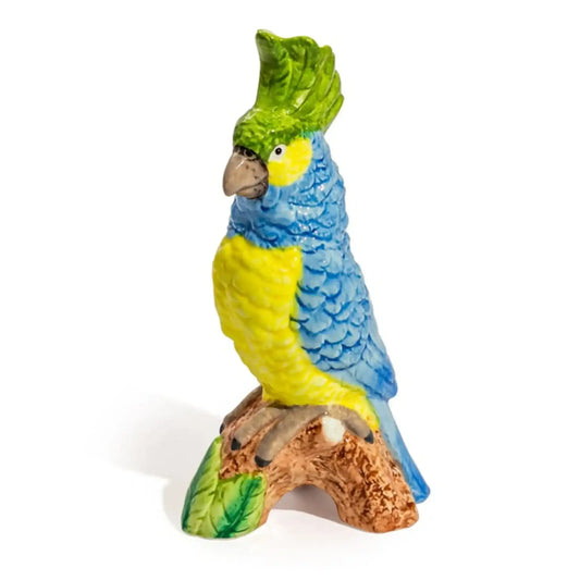 Colorful parrot figurine on a branch with a white background