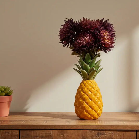 Pineapple-shaped vase with flowers on a wooden surface
