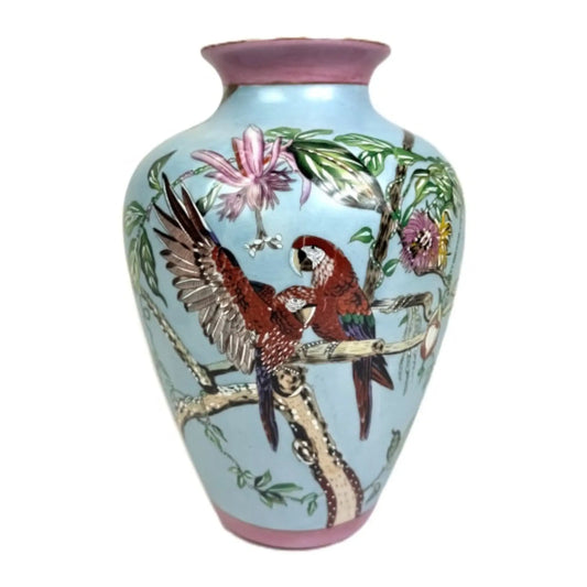 Decorative vase with parrot design on a light blue background