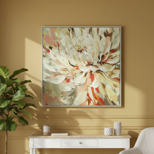 Framed floral artwork on a yellow wall above a white console table with decorative items.