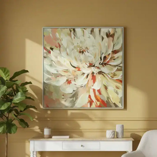 Framed floral artwork on a yellow wall above a white console table with decorative items.