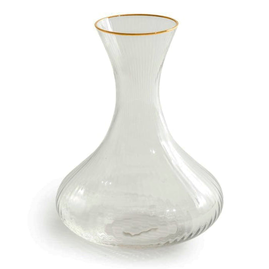 Clear glass decanter with gold rim on a white background
