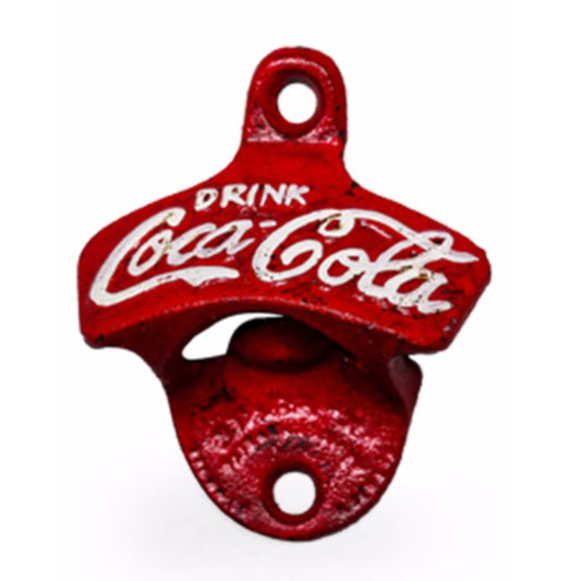A red cast iron bottle opener designed as a Coca-Cola bottle opener, featuring the white embossed Coca-Cola script and 'DRINK' text on a white background.