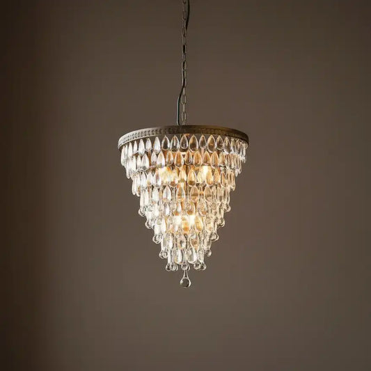 Chandelier hanging against a dark brown background