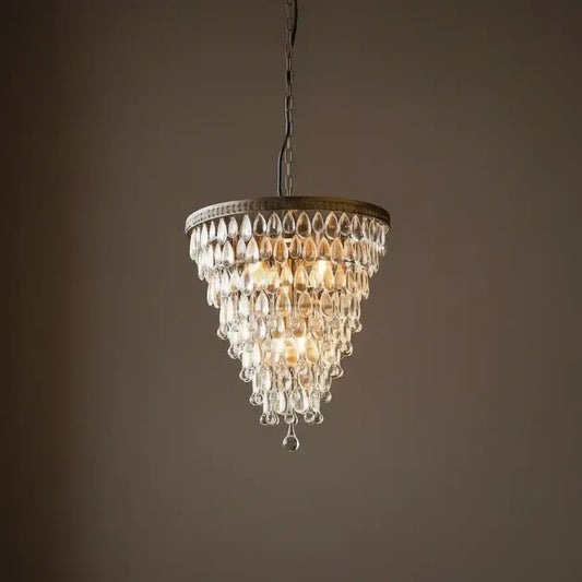 Chandelier hanging against a dark brown background