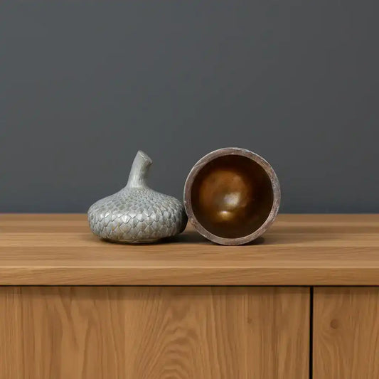 Decorative ceramic jar with textured lid on a wooden surface
