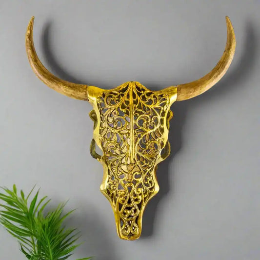 Decorative gold bull skull with long horns on a white background
