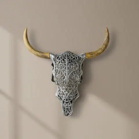 Decorative bull skull with intricate patterns on a beige background