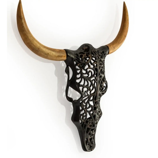 Decorative wall art with black filigree design and wooden horns on a white background