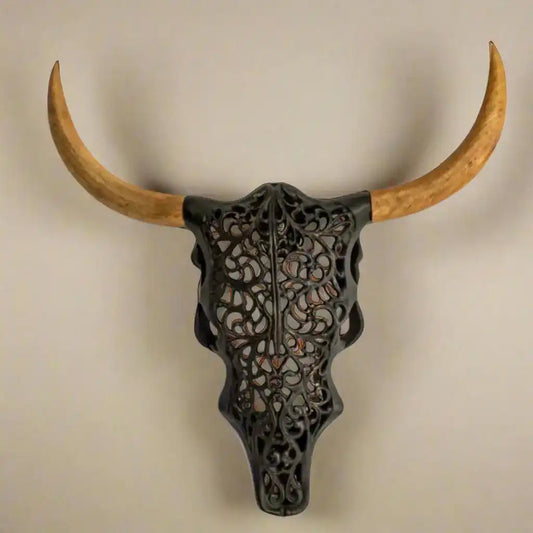 Decorative bull skull with large wooden horns on a white background