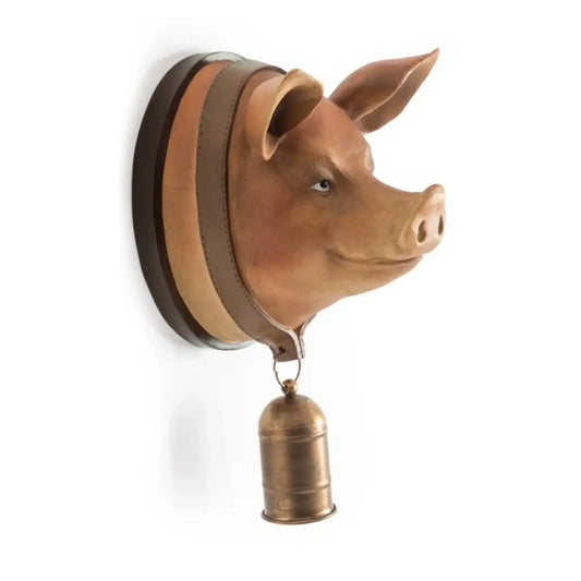 Pig head wall decoration with a bell on a white background
