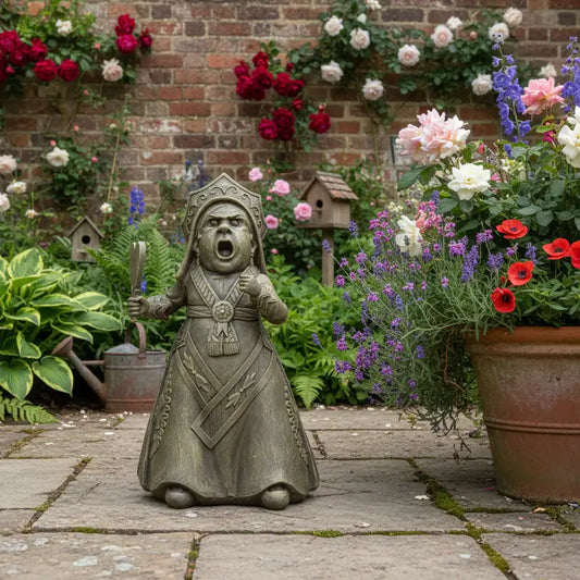 Statue of a warrior in a garden with flowers and plants