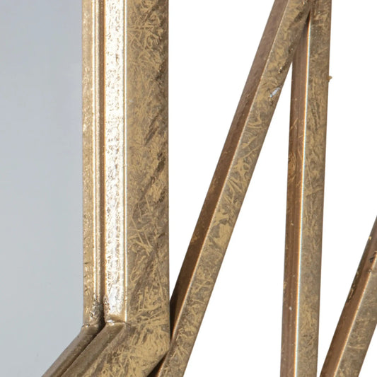 Close-up of a decorative metal frame with intricate patterns on a light gray background