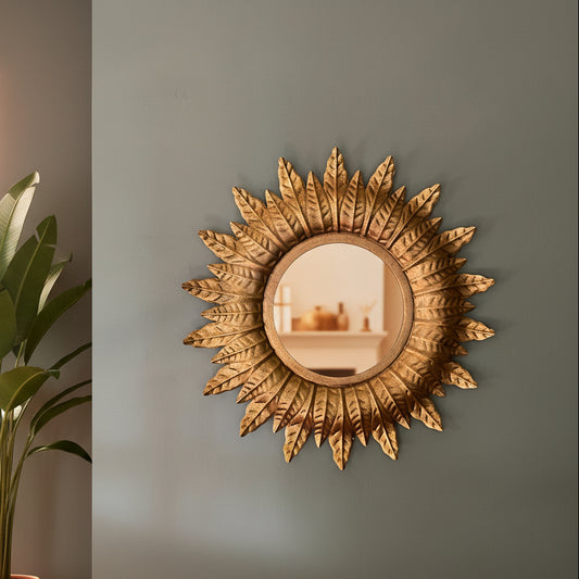 Decorative sun-shaped mirror on a plain wall
