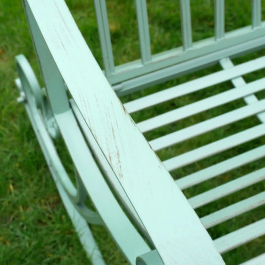 White metal bench on grass