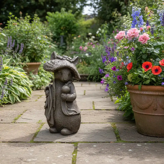 Statue of a garden gnome with a hat in a garden setting with flowers and plants.