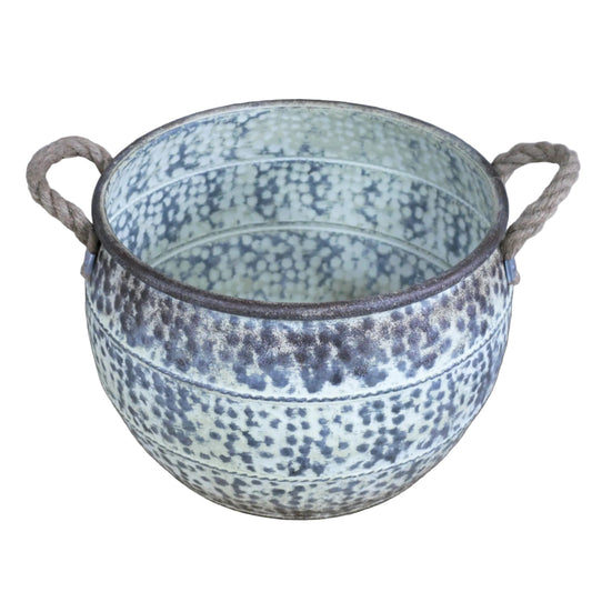 Decorative pot with speckled design and handles on a wooden surface.